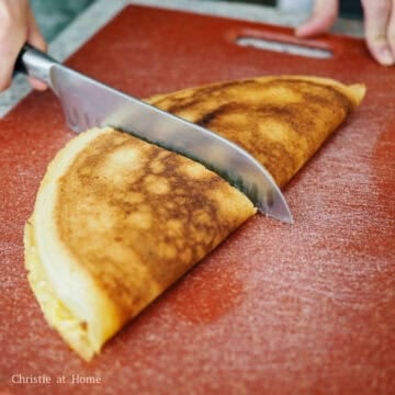 Slide the pancake onto a cutting board and slice in half with a sharp knife. Repeat this process for the two remaining pancakes. Enjoy!