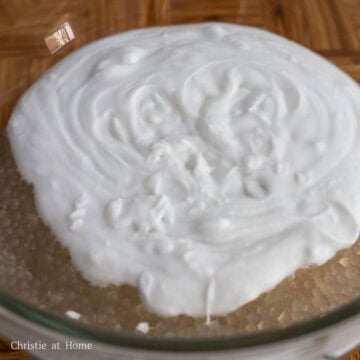 Strain the cooked tapioca with fine mesh sieve and rinse off the excess starch with cold running water until cold. Strain out as much excess water and transfer tapioca to a large bowl. Open the canned coconut milk, remove the lid and mix the contents with a fork. Then pour the coconut milk into the bowl of tapioca. 