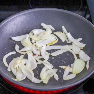 Heat vegetable oil in a medium-sized pan on medium heat. Cook sliced onions until translucent and softened.
