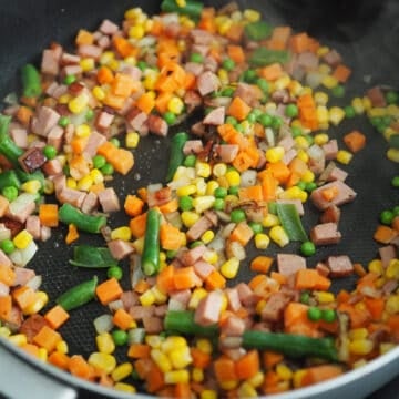 Rinse frozen mixed vegetables with cold water and strain well. Fry mixed veggies until softened, about 1-2 minutes