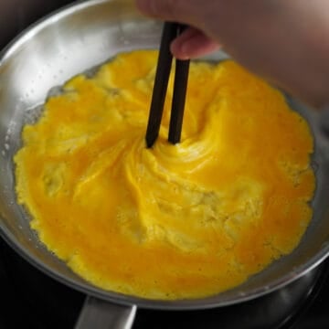 Hold the wooden chopstick in the center, only rotating the pan so your egg becomes a tornado shape.