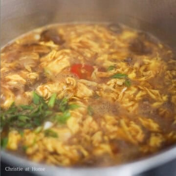 Add green onions, vinegar, and white pepper to taste.