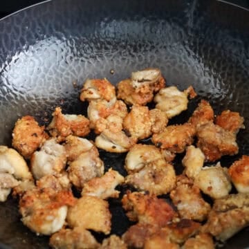 Fry chicken until golden brown and crispy.