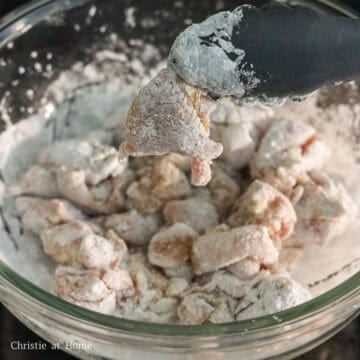 Add cornstarch to the seasoned chicken and toss until each piece is evenly coated in starch.