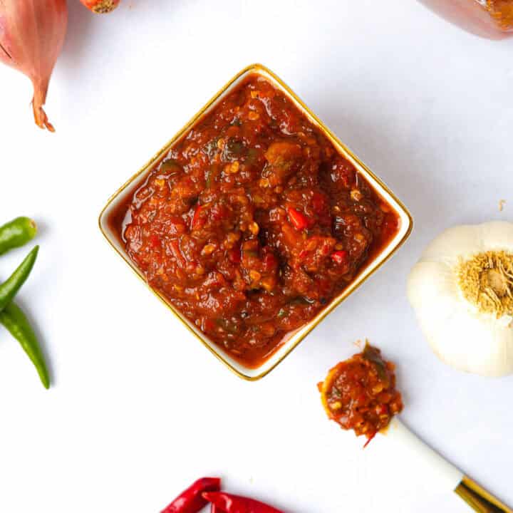 Homemade sambal oelek with a chunky, spicy chili paste texture.