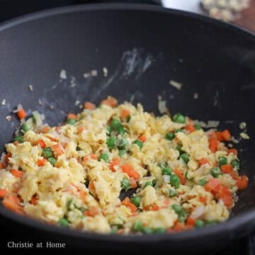 Add remaining vegetable oil into empty space. Pour in the beaten eggs, then scramble before mixing with the other ingredients.