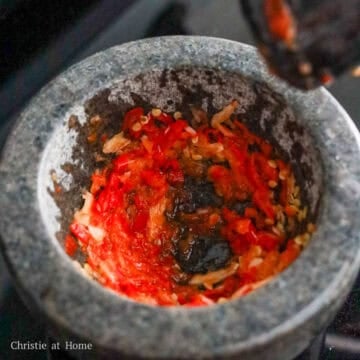 grind red chilies and garlic in a mortar and pestle or food processor