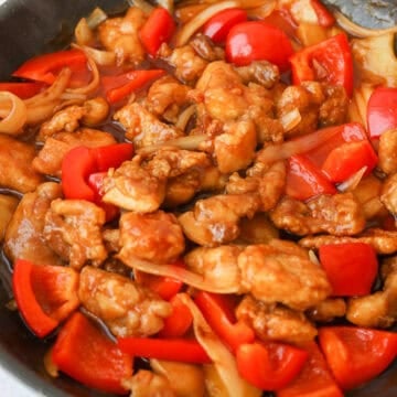 Toss in fried chicken and mix to coat evenly and garnish with sesame seeds and green onions.