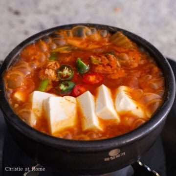 Add sliced tofu on top of the stew. Season with sesame oil. Garnish with chopped Korean chili peppers and enjoy hot with rice. 