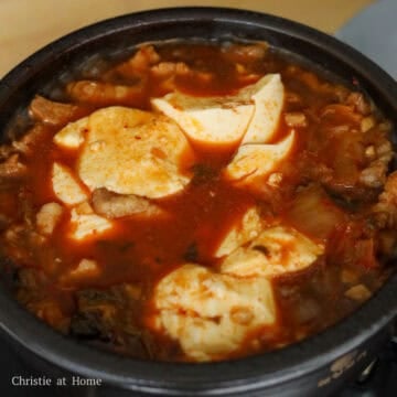 Add in soft tofu into the center of the pot. Break it up with a spoon into big chunks.
