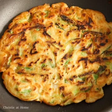 Flip the pancake over in the pan and add more oil.