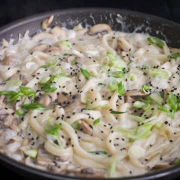 Garnish with green onions and black sesame seeds. Serve hot and enjoy.