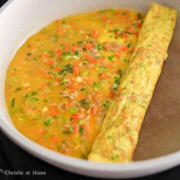 loosen the edges with a spatula and roll the omelette to the halfway point with a 1 inch thickness