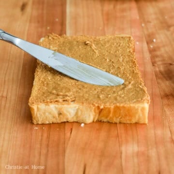 evenly spread peanut butter on two slices of bread from edge to edge leaving 1 piece without peanut butter