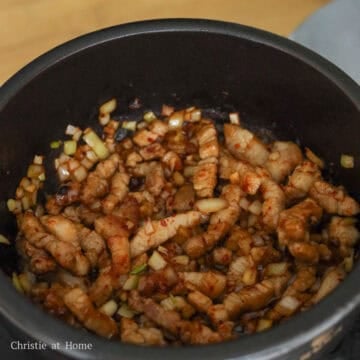 Add regular soy sauce, fish sauce, sesame oil, sugar, and gochugaru. Mix together and cook until onions become translucent, a couple minutes.