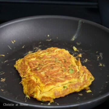 Next melt the remaining butter and swirl it around the pan. Pour the egg mixture into the pan and shape it with a spatula into a square to fit the bread. Keep shaping it until the bottom is golden brown and flip over.