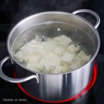 Fill a medium pot with enough water and season with salt. Bring to a boil and blanch diced tofu for 60 seconds. 