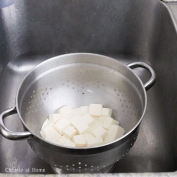 Gently strain tofu into a colander. Do not rinse off with cold water. 