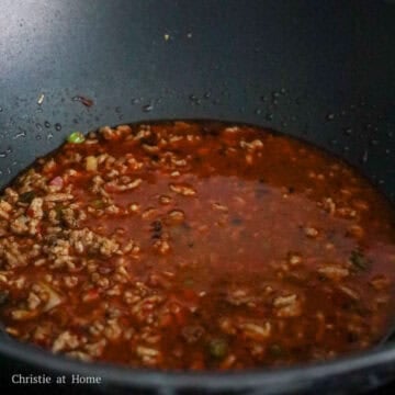 Stir in chicken bouillon powder, doubanjiang sauce, chili oil, dark soy sauce, sugar, and ground sichuan peppercorn.  Mix in the broth.  Pour in cornstarch slurry and allow the sauce to thicken. 