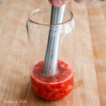In a tall glass, add strawberries and white granulated sugar and crush them with a muddler until they’re pureed. If you don’t have a muddler, finely chop or purée the strawberries in a blender and mix them in the glass with the sugar.