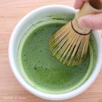 Then sift matcha powder into a small bowl. Add hot boiling water to the matcha and whisk until frothy for 30 seconds. 