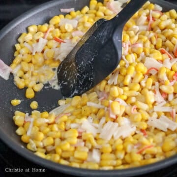 Then add mayo, sugar, black pepper, imitation crab meat and combine with the corn. Cook until liquids in the pan have evaporated for 4 to 5 minutes, uncovered.