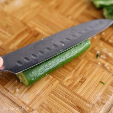 Slice the ends off the mini cucumbers. With the side of the knife, smash cucumbers a few times until they’re a bit flattened and broken down the centre.