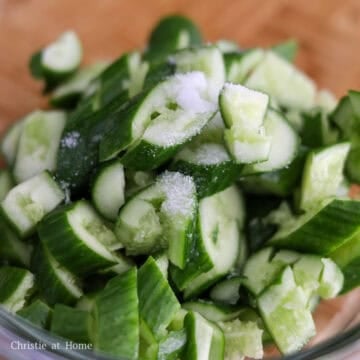 Transfer sliced cucumbers to a bowl. Add salt and massage the salt into the cucumbers. Allow cucumbers to sit in salt for 5-10 minutes to draw out excess liquids. Discard liquid.
