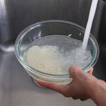 Rinse the rice grains at least 3 times until the water runs clear to remove excess starch. Strain and set aside. 
