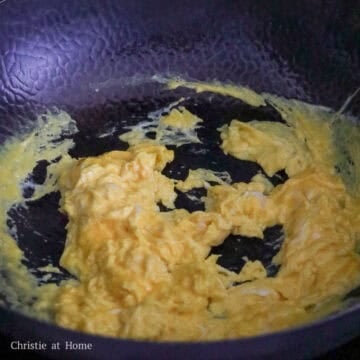 Heat vegetable oil in a large pan or wok. If you are using a wok, allow the oil to smoke and if using a normal pan, skip smoking the oil. Pour in beaten eggs. Quickly stir-fry the eggs so they take shape.