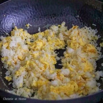 Once the eggs take shape but are still moist, quickly toss in rice. If rice is clumped together, break apart in pan.