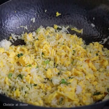 Sweep everything to the side of the pan, add remaining oil into empty space with green onions. Mix green onions into rice and eggs.
