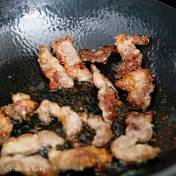 In a large pan, heat vegetable oil on medium heat.  To check if the oil is hot enough, place a wooden chopstick and look for bubbles. Then carefully lower in pork and fry until golden crispy brown on each side, about 8-9 minutes in total adjusting the heat as needed. 