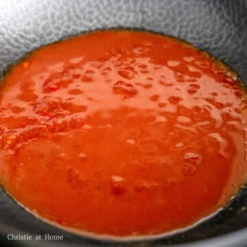 On medium heat, pour in the peking sauce into the pan and let it simmer to reduce and thicken. 