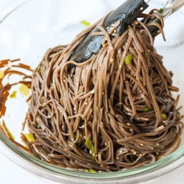 Season noodles with noodle sauce along with sesame seeds and finely chopped green onions. Mix well until noodles are lightly coated in sauce.