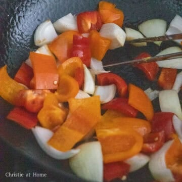 Remove most of the oil and leave 2 teaspoon in the pan. On medium heat sauté bell peppers and onions until softened, about 2-3 minutes.
