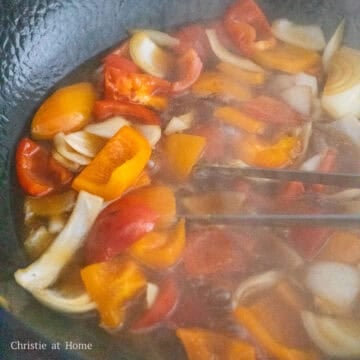 Pour in sweet and sour sauce and simmer to thicken. Once thickened, pour sauce into a medium serving bowl.