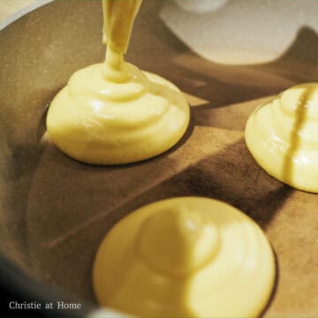 In a large non-stick pan set on low-medium heat (level 2-3 on the dial), lightly grease with vegetable oil. Once the pan is hot, add ¼ cup batter into the pan forming a 3-4 inch wide pancake. Once the first layer solidifies a bit, add a second layer to make the pancake taller.
