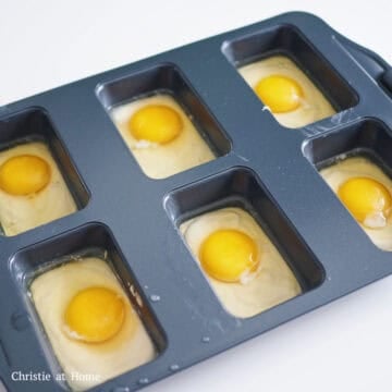 Crack an egg into each mold over the bread batter. Pierce the egg yolks with a toothpick so the yolk can spread out across as it bakes. 