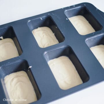 Equally pour and divide the bread batter into the baking molds to fill them halfway. 