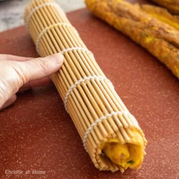 Transfer to the rolled omelette to a bamboo mat or plastic wrap. Roll it tight to mold it into a circular log. Set aside as you work on making the remaining two egg rolls. 
