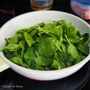 Next in the same pan set over medium heat, add 1 teaspoon sesame oil and add baby spinach. Cook until softened and dark green. Remove and set aside.