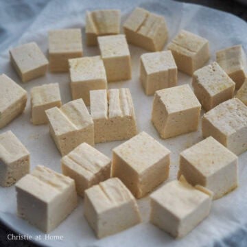 Then generously season tofu cubes with an even sprinkle of salt, garlic powder, onion powder on both sides.
