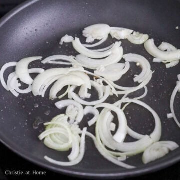 Heat vegetable oil in a large pan on medium heat. Cook sliced onions until translucent, about 1-2 minutes. 