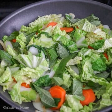 Next stir fry carrots, cabbage, rice cakes and perilla leaves until cabbage has softened, about 3-4 minutes.