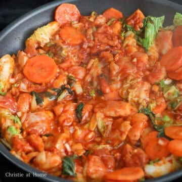 Add chicken along with marinade sauce and stir-fry with other ingredients. Spread evenly across the pan. Fry chicken for 10 minutes, flipping over half way.