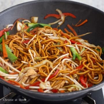 Add the noodles to the pan. Give the noodle sauce another mix and pour it around the noodles. Toss everything together. Toss in the cooked chicken, green onions and bean sprouts and mix with noodles for 20 seconds. Transfer noodles to a large serving plate and enjoy!