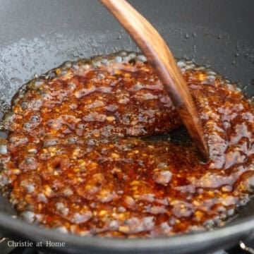 Pour the honey garlic sauce into the pan and simmer to thicken it. When it's thick enough, it will coat the back of a spoon and not immediately drip off. 