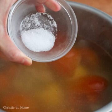 Skim the soup to remove any oil or scum and season with salt and chicken bouillon.